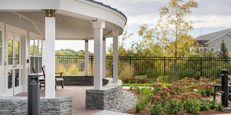 Contextual Image that shows a stone porch with a patio that leads into a secure courtyard.